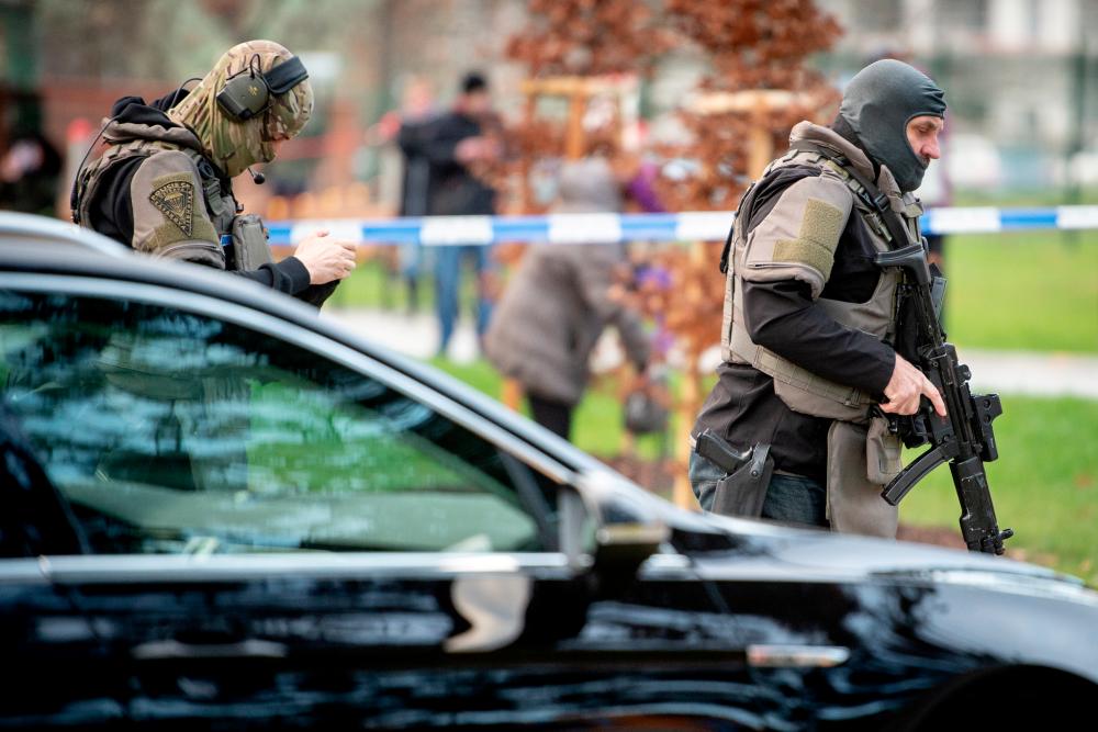 Police officers are seen near the site of a shooting in front of a hospital in Ostrava, Czech Republic, Dec 10. — Reuters
