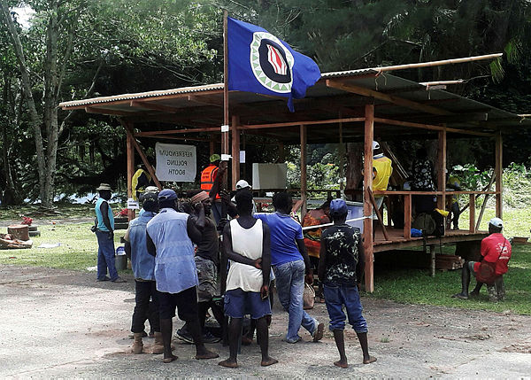 Filepix showing residents hold a Bougainville flag at a polling station during a non-binding independence referendum in Arawa, on the Papua New Guinea island of Bougainville Nov 26, 2019 — Reuters