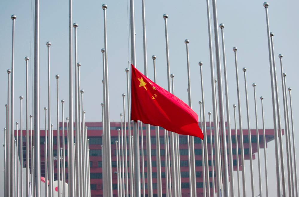 File photo shows the Chinese flag raised in front of the China Pavilion during a flag raising ceremony at the Shanghai World Expo site in Shanghai on April 30, 2010. — Reuters