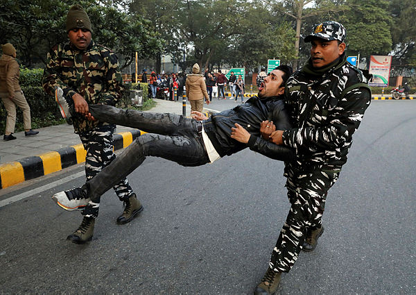 A demonstrator reacts as he is detained by police during a protest against a new citizenship law, in New Delhi, India, Dec 27, 2019 — Reuters