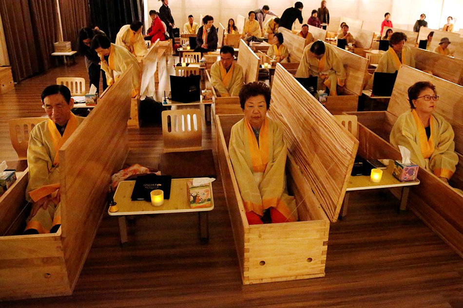 Filepix of participants sitting inside coffins during a “living funeral” event as part of a “dying well” program in Seoul, South Korea at Oct 31 — Reuters
