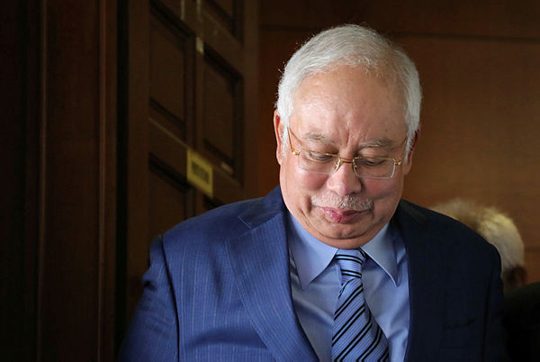Former prime minister Datuk Seri Najib Abdul Razak walks out of a courtroom for a break at Kuala Lumpur High Court yesterday. — Bernama