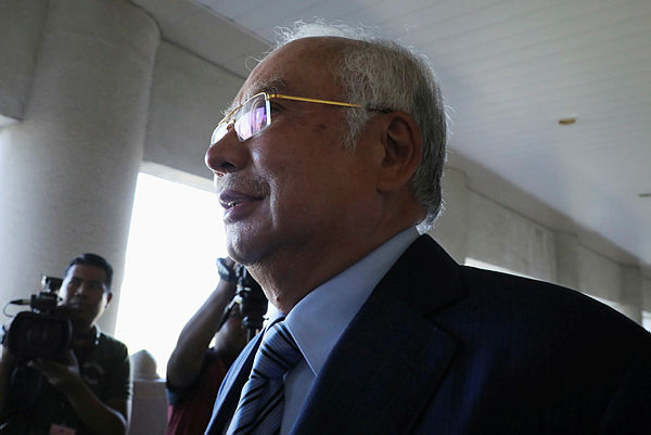 Former prime minister Datuk Seri Najib Abdul Razak’ walks out of a courtroom for a break at Kuala Lumpur High Court Jan 6. — Reuters