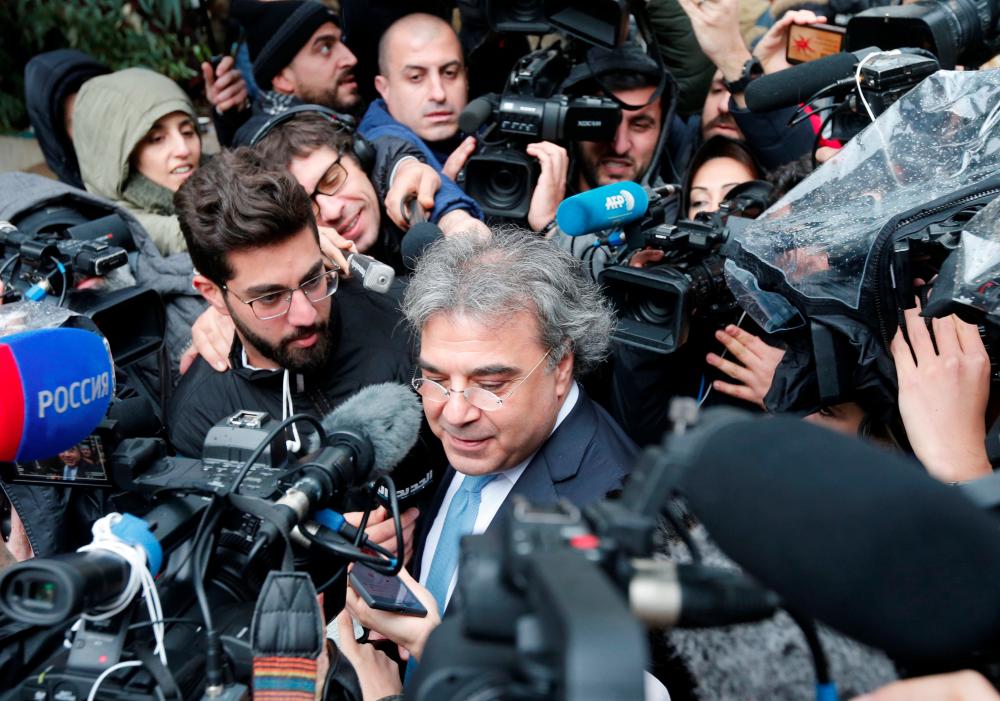 The lawyer of former Nissan chairman Carlos Ghosn speaks to the media after Ghosn's questioning, outside the Justice Palace in Beirut, Lebanon, Jan 9. — Reuters