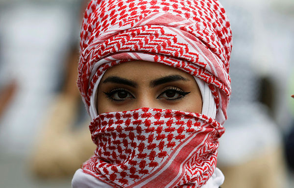 An Iraqi university student poses for the camera with her face covered, during ongoing anti-government protests, in Baghdad, Iraq Jan 19, 2020 — Reuters