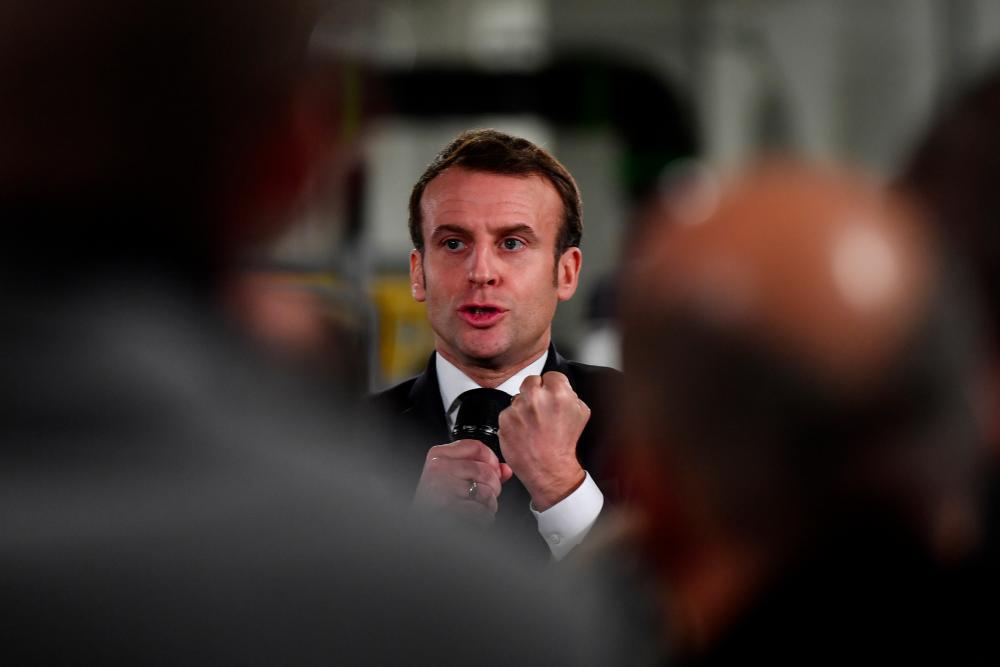 French President Emmanuel Macron speaks during a visit at the AstraZeneca factory in Dunkirk, France on Jan 20. — Reuters