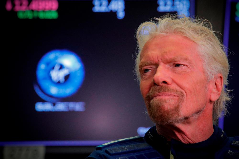Sir Richard Branson stands on the floor of the New York Stock Exchange (NYSE) ahead of Virgin Galactic (SPCE) trading in New York, U.S., October 28, 2019. REUTERS/Brendan McDermid/File Photo
