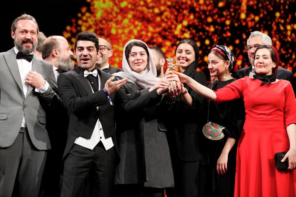 Mohammad Seddighimehr, Jila Shahi, Mahtab Servati, Baran Rasoulo and Kaveh Ahangar pose with the Golden Bear for Best Film for “There Is No Evil” during the awards ceremony at the 70th Berlinale International Film Festival in Berlin, Germany, February 29, 2020. REUTERS/Fabrizio Bensch