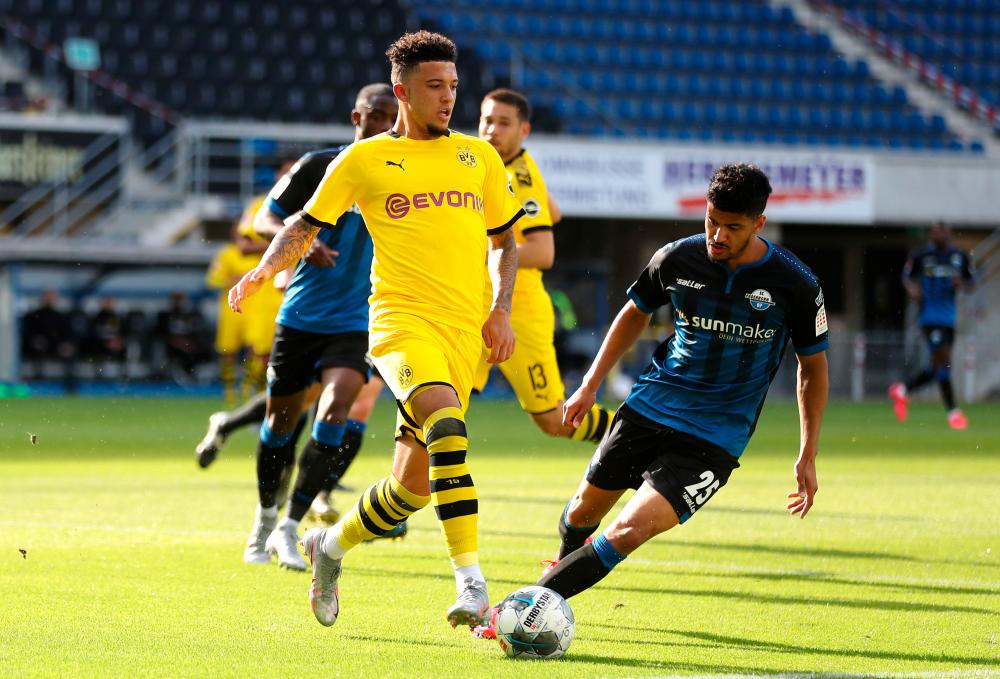 Paderborn’s Mohamed Drager (right) in action with Borussia Dortmund’s Jadon Sancho during the German Bundesliga match at the Benteler Arena in Paderborn on May 31, 2020. – REUTERSPIX