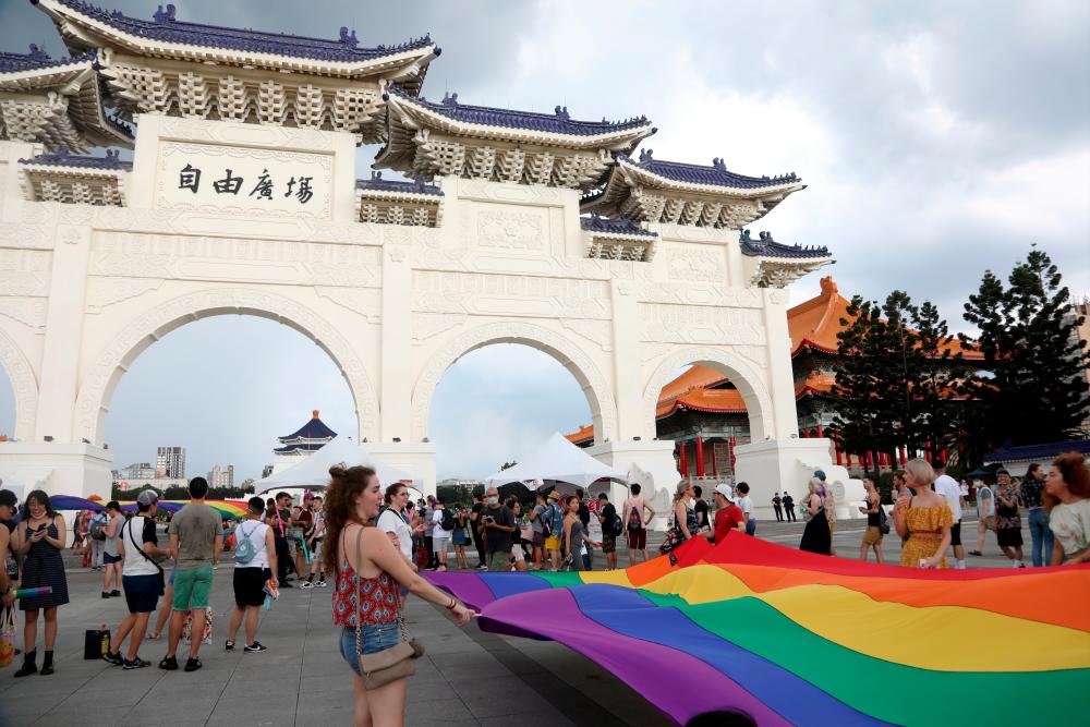 People carry a giant rainbow flag during the “Taiwan Pride Parade For the World” rally in Taipei, Taiwan, June 28, 2020. — Reuters