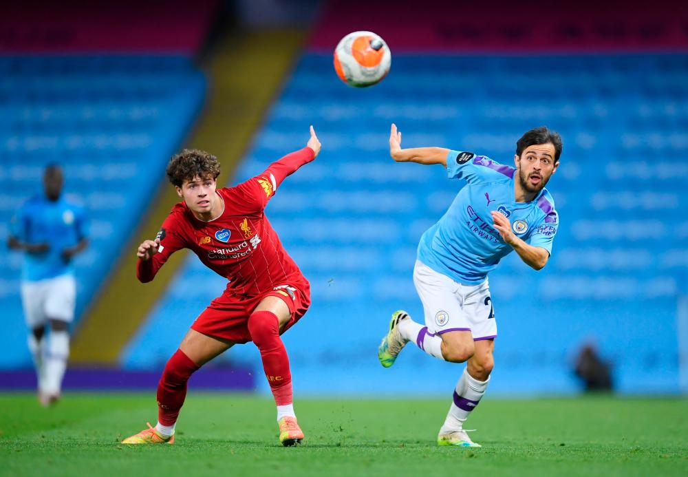 Liverpool’s Neco Williams in action with Manchester City’s Bernardo Silva, as play resumes behind closed doors following the outbreak of the coronavirus disease (COVID-19). — Reuters