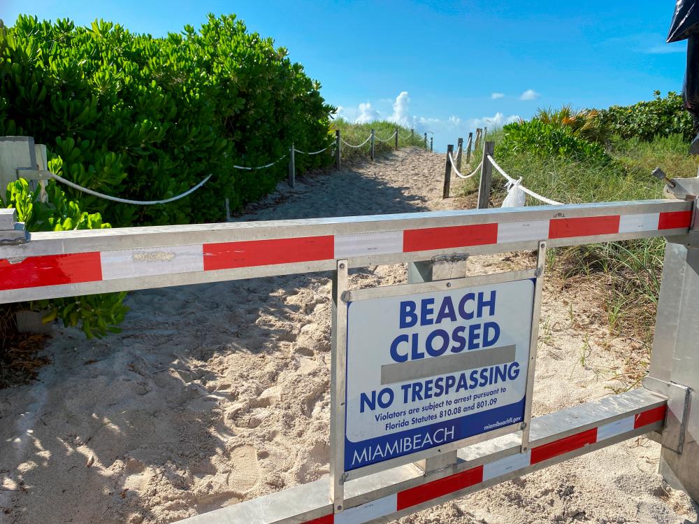 A sign informing about South Beach closure, to prevent the spread of the coronavirus disease (Covid-19), is seen ahead of the Fourth of July weekend, in Miami Beach, Florida, US, July 3, 2020. — Reuters