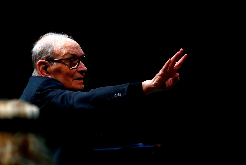 Italian composer Ennio Morricone conducts a concert in Berlin, Germany, January 21, 2019. REUTERS/Fabrizio Bensch/File Photo