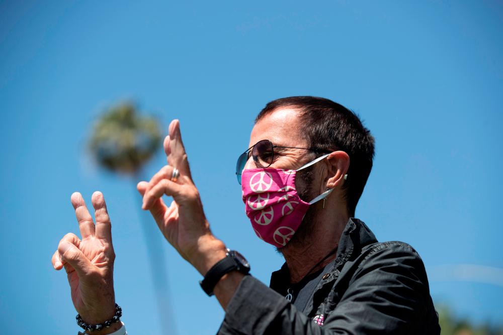 Musician Ringo Starr wears a face mask as he poses to celebrate his 80th birthday during the outbreak of the coronavirus disease (COVID-19), in Beverly Hills, California, U.S., July 7, 2020. REUTERS/Mario Anzuoni