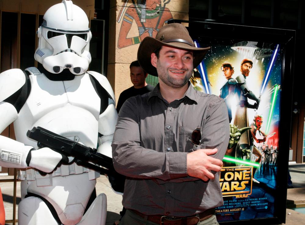 Dave Filoni, director of the new animated film Star Wars: The Clone Wars, poses with a Storm Trooper character at the film’s US premiere in Hollywood, California August 10, 2008. REUTERS/Fred Prouser/File Photo