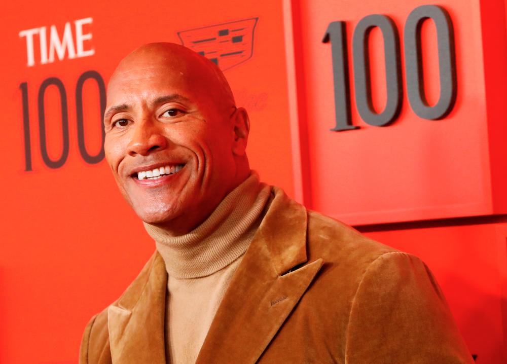 FILE PHOTO: Dwayne “The Rock” Johnson poses upon arriving for the Time 100 Gala celebrating Time magazine’s 100 most influential people in the world in New York, U.S., April 23, 2019. REUTERS/Andrew Kelly/File Photo