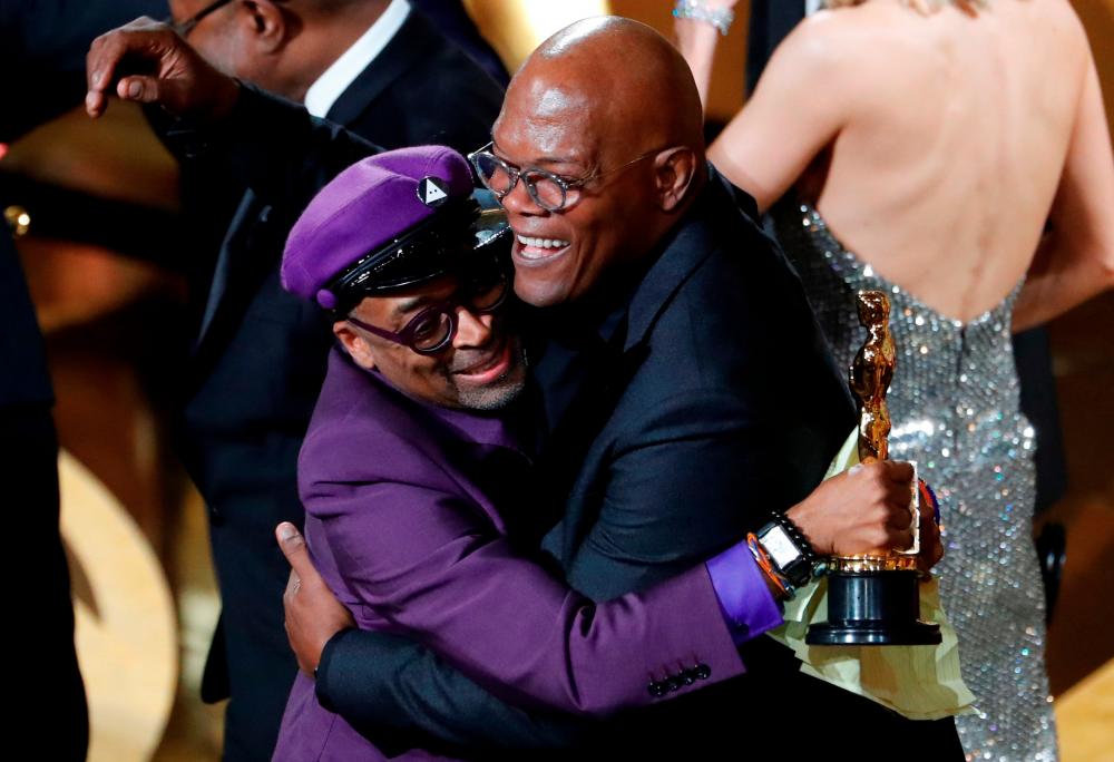 FILE PHOTO: 91st Academy Awards - Oscars Show - Hollywood, Los Angeles, California, U.S., February 24, 2019. Film director Spike Lee (L) embraces presenter Samuel L. Jackson as he wins his first Oscar, the “Best Adapted Screenplay” award for “BlacKkKlansman.” REUTERS/Mike Blake/File Photo