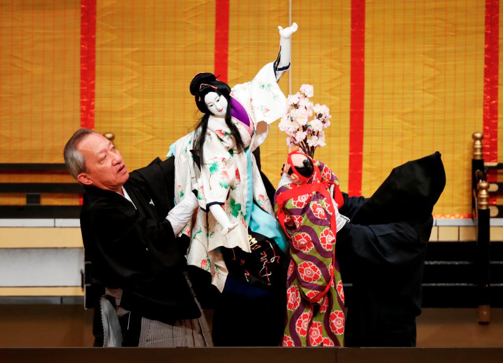 anjuro Kiritake, a Bunraku puppeteer who was designated a Living National Treasure by the Japanese government, performs Japan’s traditional puppet drama called ‘Bunraku’, which emerged in 15th century and the characters are manipulated by three puppeteers, during a program titled Komochi Yamanba (The Pregnant Mountain Ogress) at the National Theatre in Tokyo, Japan September 7, 2020. Picture taken September 7, 2020. REUTERS/Issei Kato