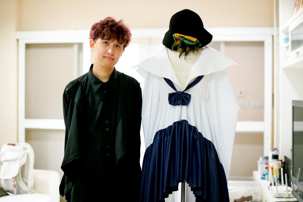 Thai designer Tin Tunsopon poses with one of his creations aiming to be an alternative to the school uniforms that are mandatory in the country, at his studio in Bangkok, Thailand September 15, 2020. Picture taken September 15, 2020. REUTERS/Jorge Silva