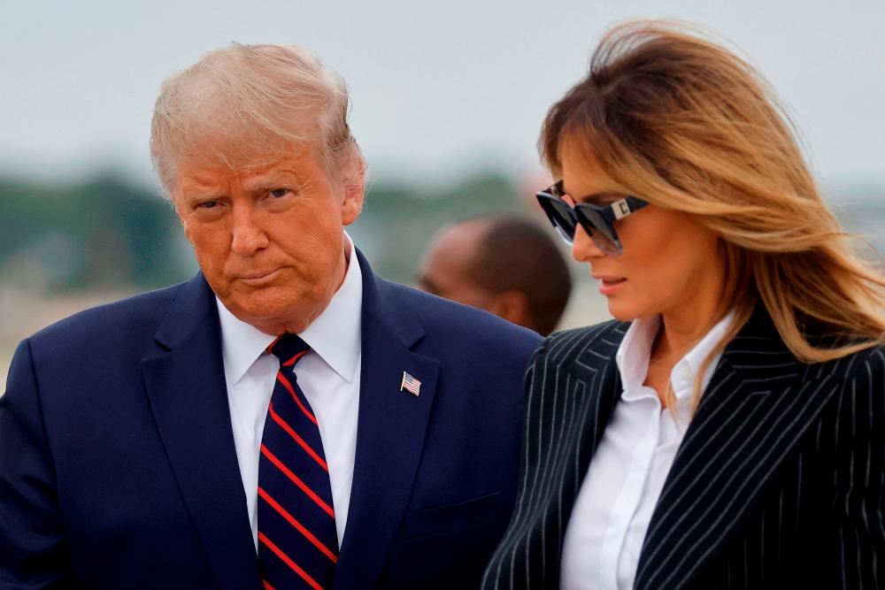 FILE PHOTO: President Donald Trump, who played down the threat of the coronavirus pandemic for months, said October 2 that he and his wife Melania had tested positive for COVID-19 and were going into quarantine, upending the race for the White House. REUTERS/Carlos Barria/File Photo
