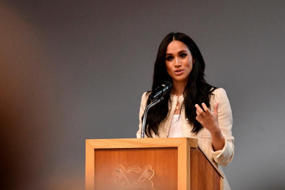 FILE PHOTO: Britain’s Meghan, Duchess of Sussex speaks during a school assembly as part of a visit to Robert Clack School in Essex, Britain March 6, 2020, in support of International Women’s Day. Ben Stansall/Pool via REUTERS/File Photo