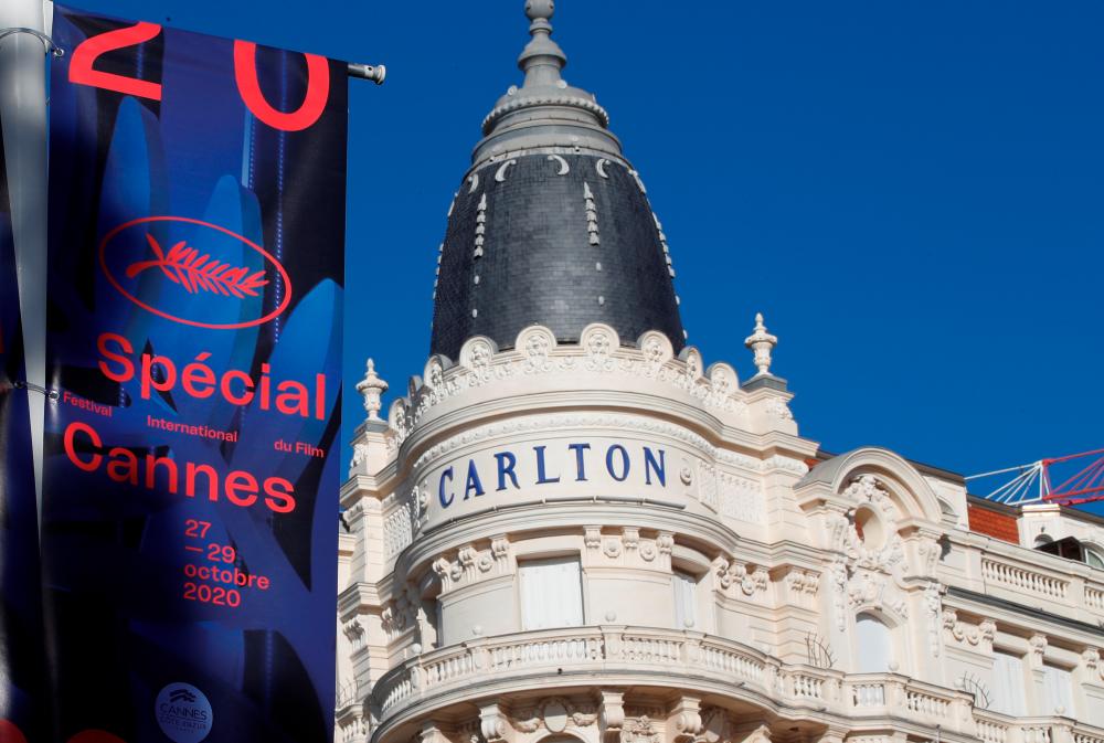 The official poster for the “Cannes 2020 Special” event is seen in front the closed Carlton Hotel on the Croisette in Cannes, France, October 27, 2020. The event, which will run from October 27 to 29, is a slimmed down version of 2020’s Cannes Film Festival, five months after the cinema showcase was cancelled due to the coronavirus disease (COVID-19) outbreak. REUTERS/Eric Gaillard