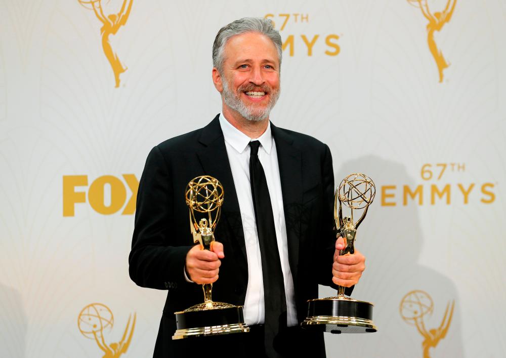 FILE PHOTO: Jon Stewart holds his awards for Outstanding Writing For A Variety Series and Outstanding Variety Talk Series for Comedy Central’s “The Daily Show With Jon Stewart” during the 67th Primetime Emmy Awards in Los Angeles, California September 20, 2015. REUTERS/Mike Blake/File Photo