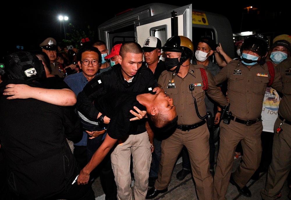 Panupong Jadnok is carried by police at Prachachuen police station in Bangkok October 30, 2020. — Reuters