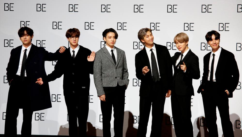 FILE PHOTO: Members of K-pop boy band BTS pose for photographs during a news conference promoting their new album “BE(Deluxe Edition)” in Seoul, South Korea, November 20, 2020. REUTERS/Heo Ran/File Photo