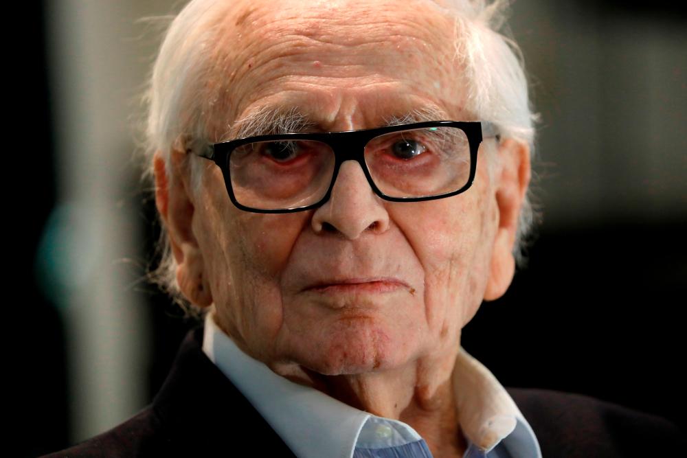 FILE PHOTO: French fashion designer Pierre Cardin, 97, poses during a presentation of a collection made in partnership with Pierre Courtial, a young designer he trained himself at his Studio Pierre Cardin in Paris, France, February 27, 2020. REUTERS/Charles Platiau/File Photo