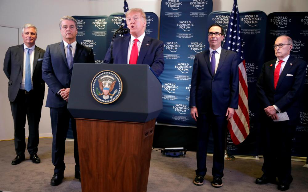 US President Donald Trump holds a news conference next to White House National Security Adviser Robert O'Brien, Director-General of World Trade Organization Roberto Azevedo, US Treasury Secretary Steven Mnuchin and White House economic advisor Larry Kudlow, at the 50th World Economic Forum (WEF) in Davos, Switzerland, January 22, 2020. - Reuters