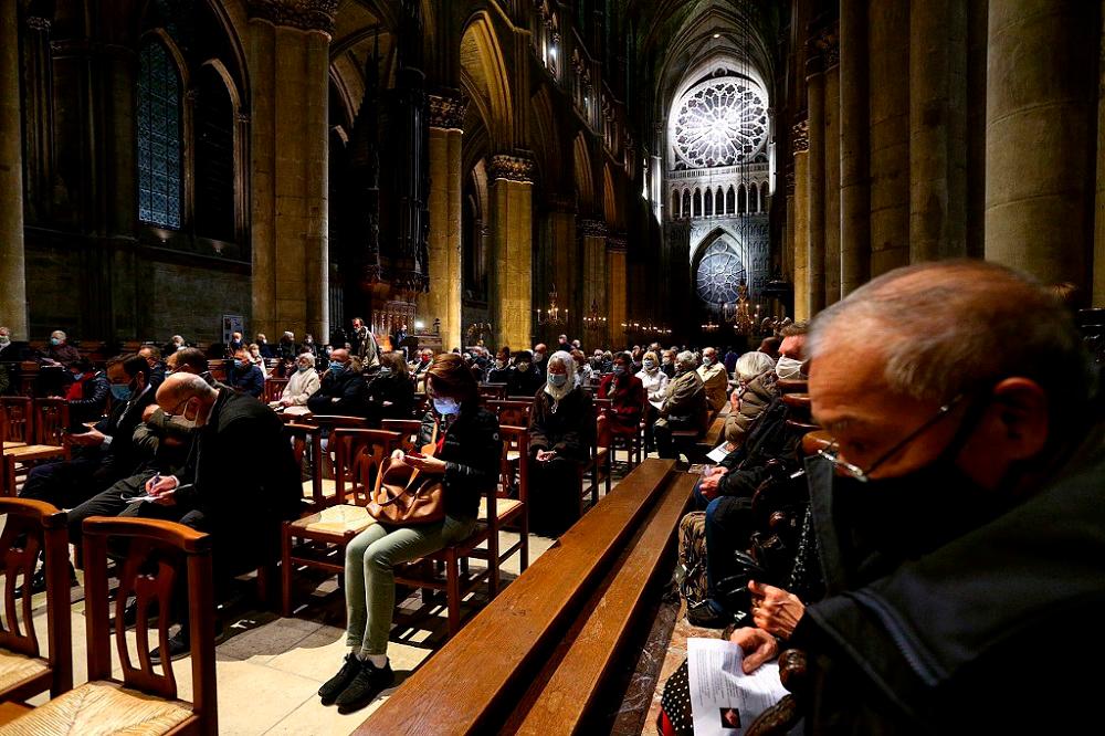 People attend a ‘mass for France’ in homage to the three victims of a knife attack at a church in Nice the previous day, at the Notre-Dame de Reims cathedral in Reims, eastern France October 30, 2020. — AFP