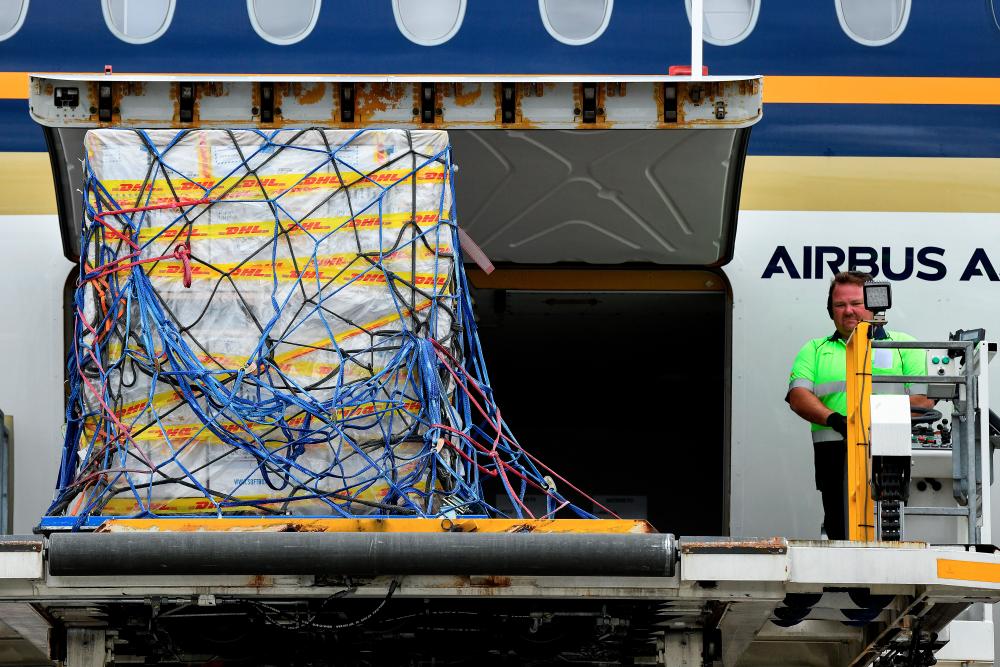 The first Australian shipment of Pfizer coronavirus disease (COVID-19) vaccines is unloaded from a Singapore Airlines plane at Sydney International Airport, Australia, February 15, 2021. AAP Image/Bianca De Marchi/via REUTERS