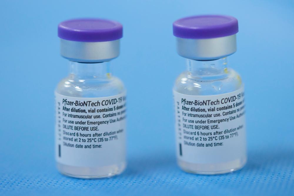 FILE PHOTO: Vials of the Pfizer-BioNTech vaccine are pictured in a vaccination center as part of the coronavirus disease (COVID-19) vaccination campaign in Geneva, Switzerland February 3, 2021. - Reuters