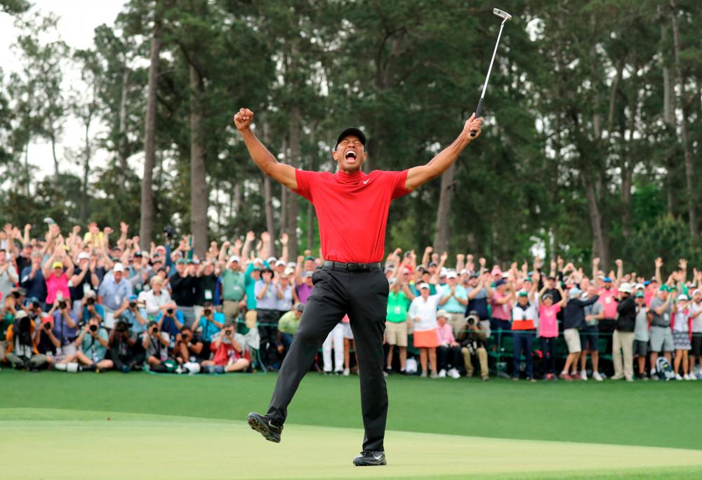 FILE PHOTO: Golf - Masters - Augusta National Golf Club - Augusta, Georgia, U.S. - April 14, 2019. Tiger Woods of the U.S. celebrates on the 18th hole to win the 2019 Masters.- Reuters