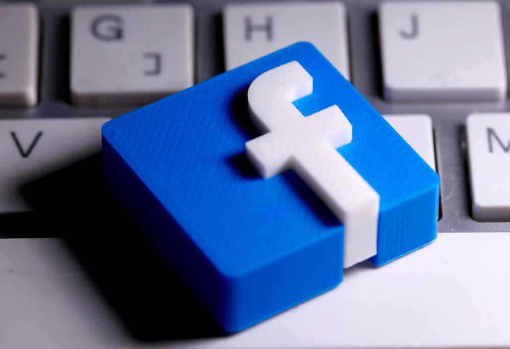 FILE PHOTO: A 3D-printed Facebook logo is seen placed on a keyboard in this illustration taken March 25, 2020. - Reuters
