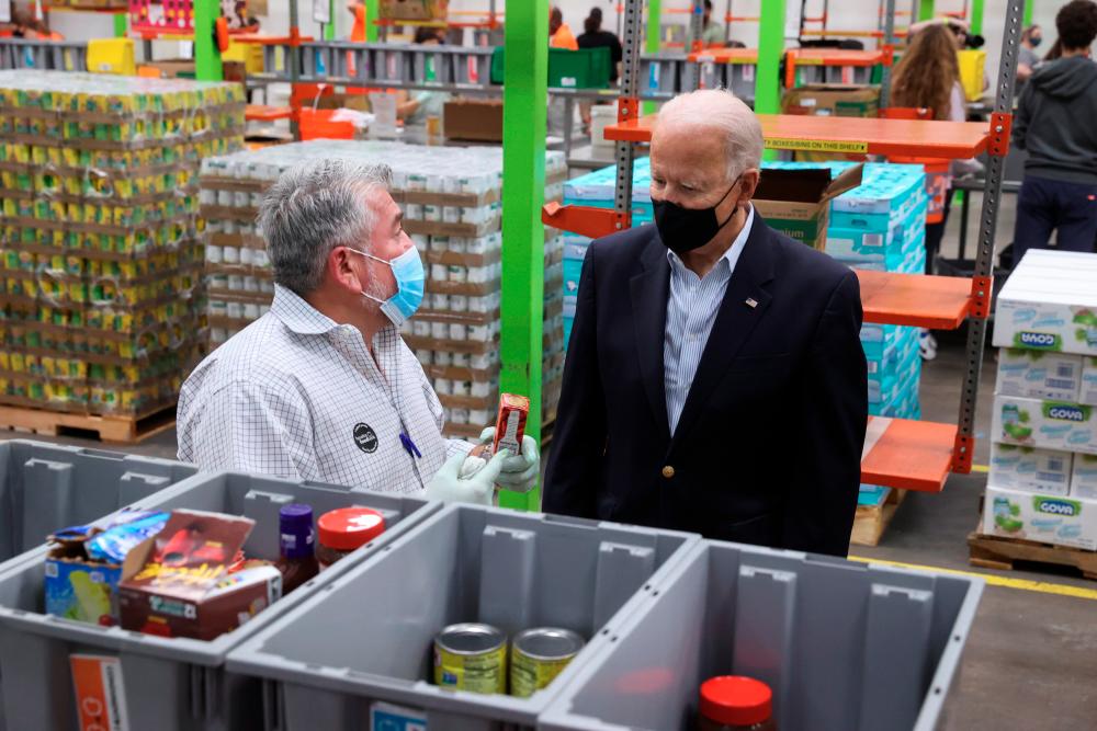 U.S. President Joe Biden tours the Houston Food Bank in Houston, Texas, U.S., February 26, 2021. - Reuters