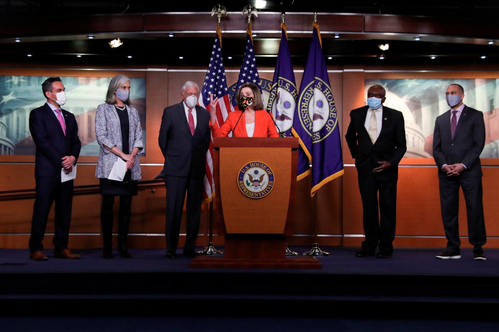 US House Speaker Nancy Pelosi (D-CA) is flanked by House Democratic leaders as she speaks during a news conference to kickoff a two-day House Democratic Caucus virtual event at the US Capitol in Washington, on March 2. - Reuters