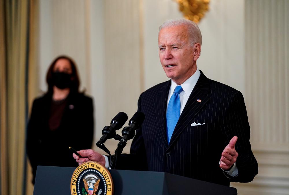 US President Joe Biden speaks about the Biden administration’s coronavirus disease (Covid-19) pandemic response as Vice President Kamala Harris listens in the State Dining Room at the White House in Washington, U.S., March 2, 2021. - Reuters