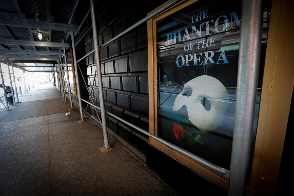 FILE PHOTO: A poster for the popular show “The Phantom of The Opera” is seen on the exterior of the shuttered Majestic Theatre in New York, U.S., July 2, 2020. - Reuters