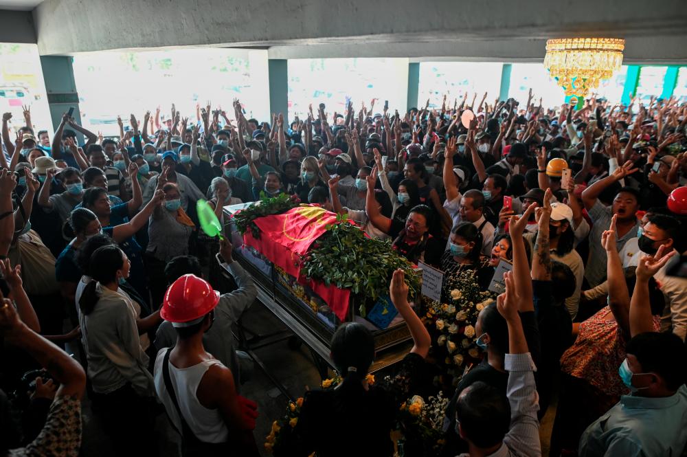 People attend the funeral of victims shot dead during the anti-coup protest in Yangon, Myanmar, March 5, 2021. - Reuters