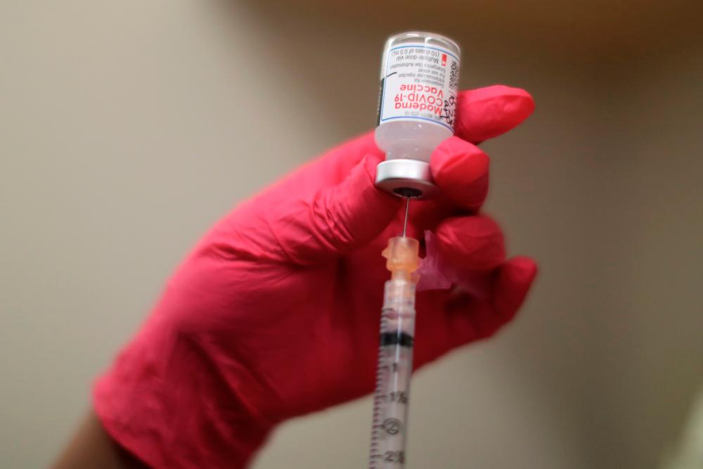 A nurse draws a Moderna coronavirus disease (Covid-19) vaccine, at East Valley Community Health Center in La Puente, California, U.S., March 5, 2021. - Reuters