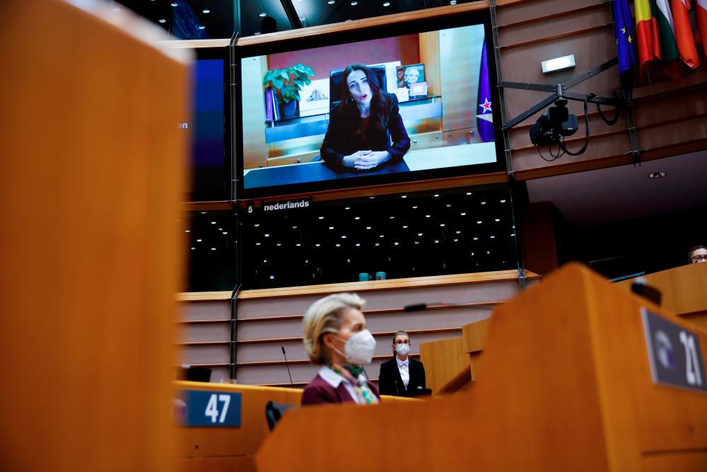 New Zealand’s Prime Minister Jacinda Ardern, on-screen, addresses European lawmakers during a plenary to mark International Women’s Day at the European Parliament in Brussels, Belgium March 8, 2021. - Reuters