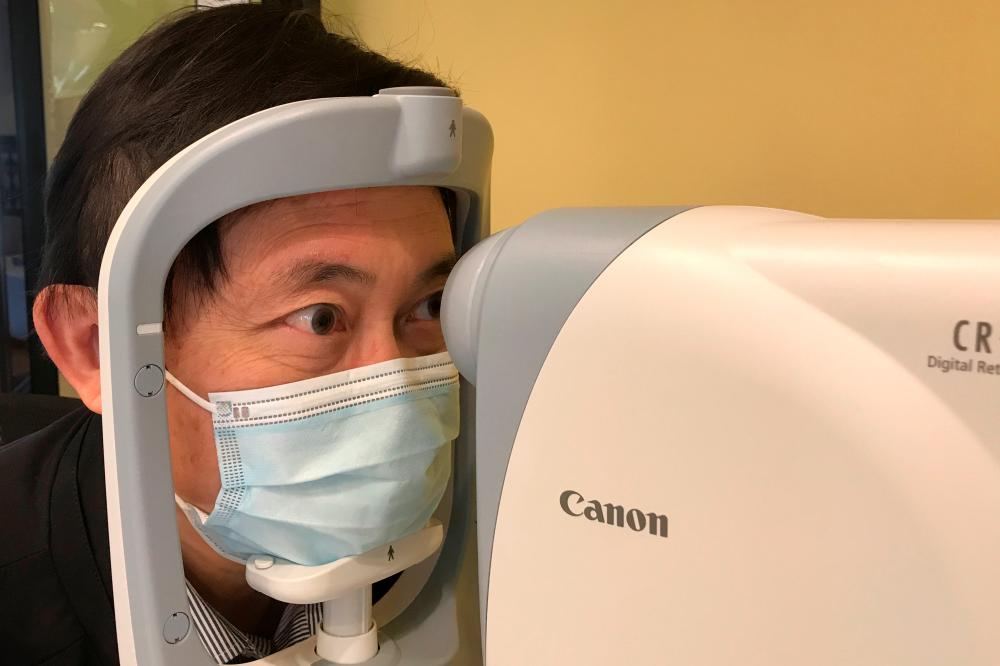 Benny Zee, a scientist from the Chinese University of Hong Kong, demonstrates retinal eye scanning technology used for early detection of autism during an interview with Reuters in Hong Kong, China January 29, 2021. Picture taken January 29, 2021. - Reuters