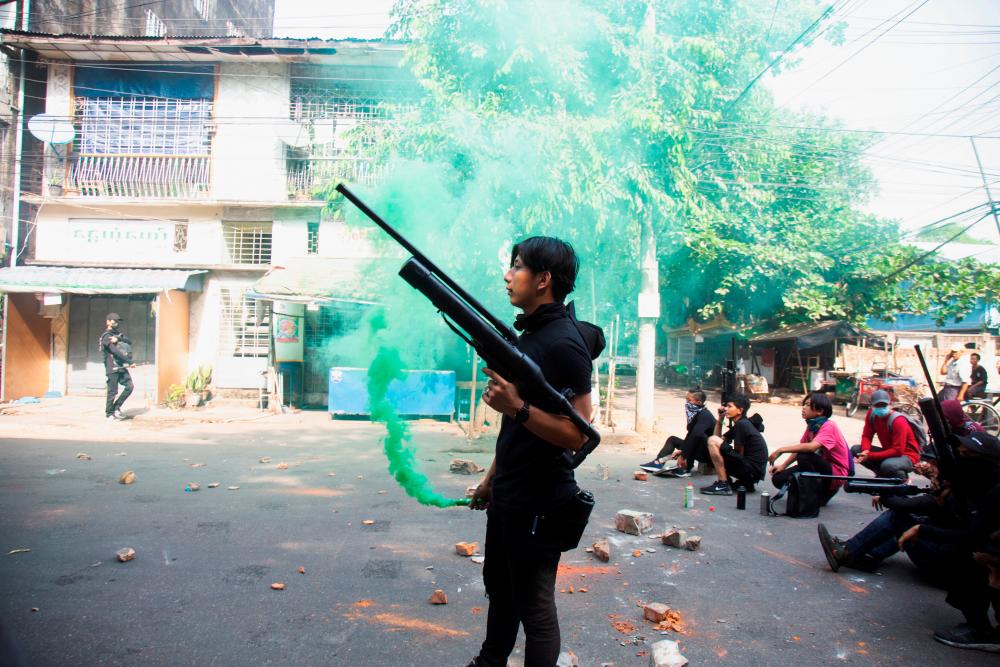 A protester holds a homemade pipe air gun during a protest against the military coup in Yangon, Myanmar April 3, 2021. - Reuters