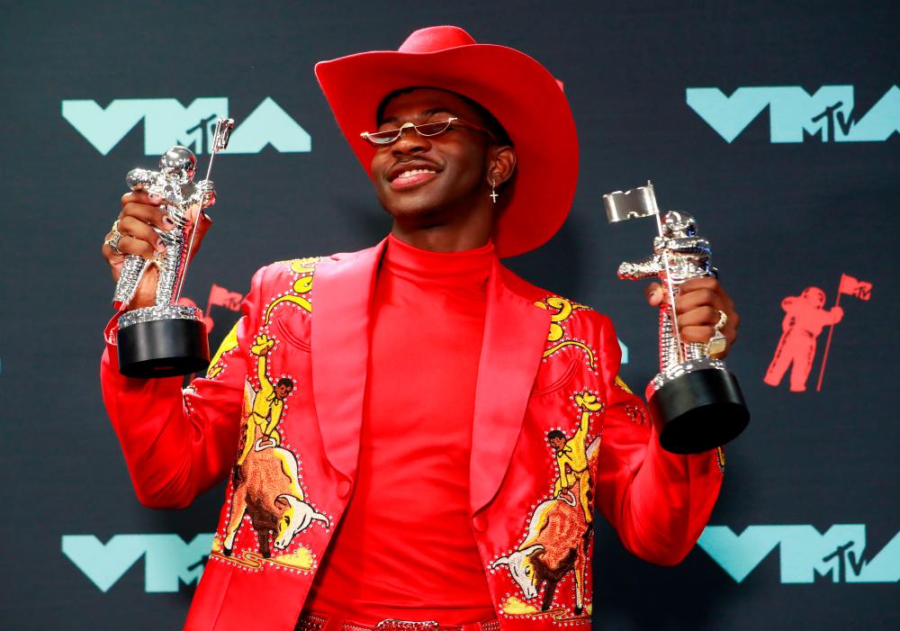 FILE PHOTO: 2019 MTV Video Music Awards - Photo Room - Prudential Center, Newark, New Jersey, U.S., August 26, 2019 - Lil Nas X poses backstage with his awards, including for Song of the Year for Old Town Road (Remix). –Reuters