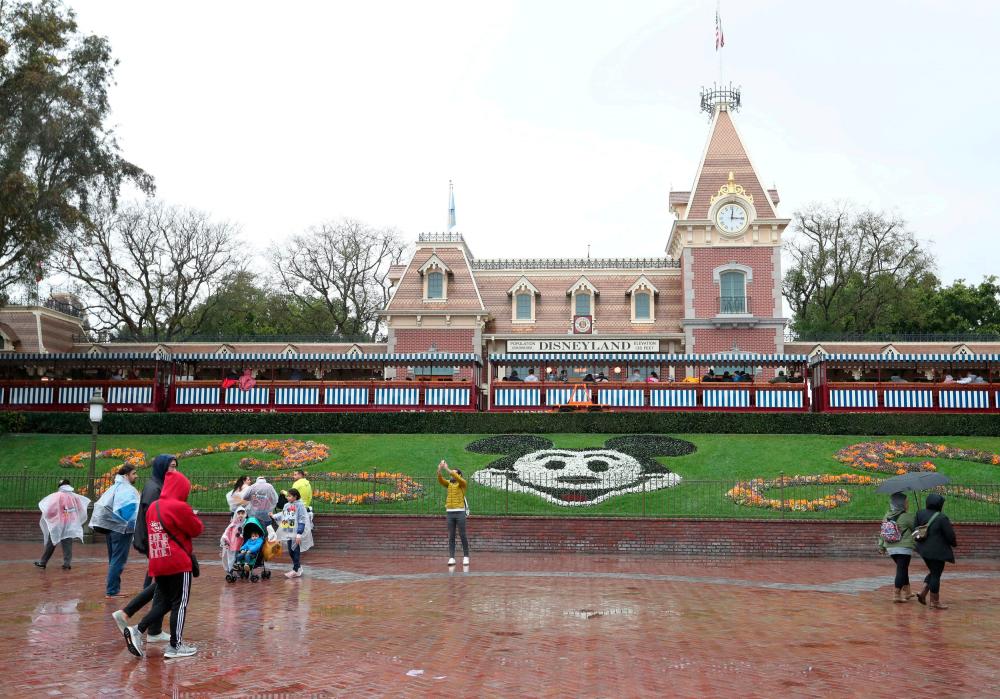 FILE PHOTO: A general view of the entrance of Disneyland theme park in Anaheim, California, U.S., March 13, 2020. –Reuters