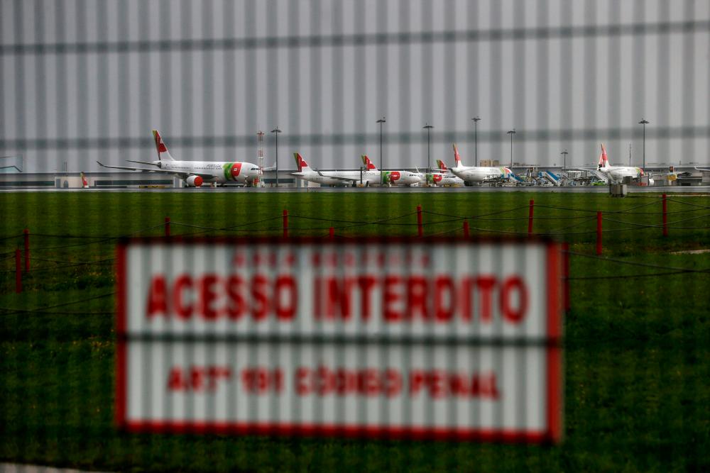 FILE PHOTO: Planes are seen at Lisbon's airport, Portugal, December 11, 2020. –Reuters