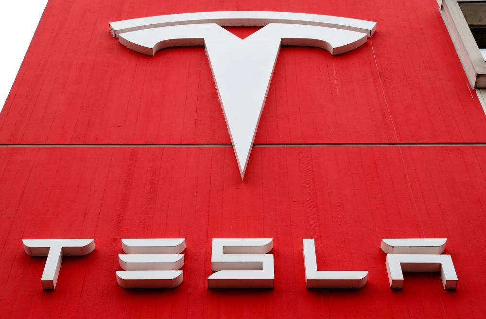 FILE PHOTO: The logo of car manufacturer Tesla is seen at a branch office in Bern, Switzerland October 28, 2020. –Reuters