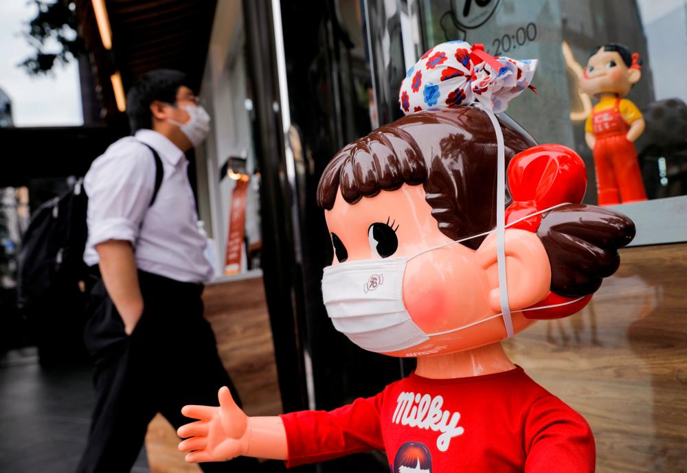 A mannequin known as 'Peko-chan' wearing a protective mask is displayed at Fujiya store, amid the coronavirus disease (COVID-19) outbreak, in Tokyo, Japan April 22, 2021. –Reuters